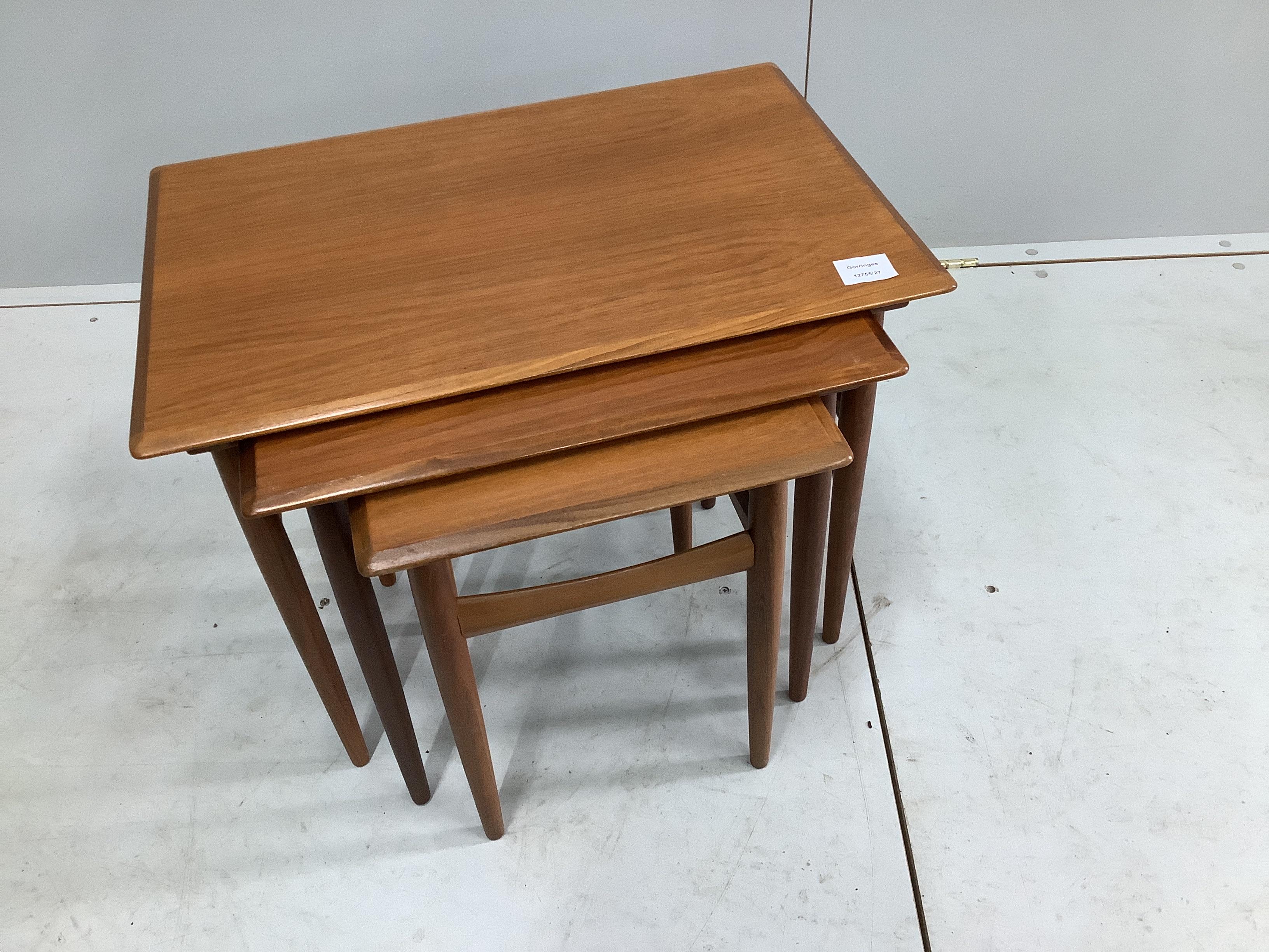 A nest of three mid century teak tea tables, width 59cm, depth 40cm, height 47cm